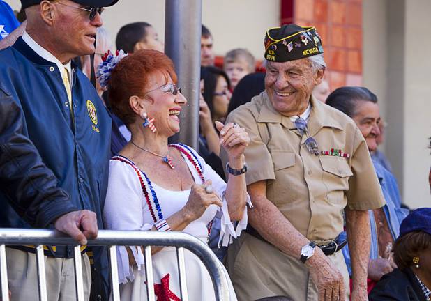 Millie Caruso and World War II veteran Gaetano Benza, 88, enjoy the annual Veterans Day parade in downtown Las Vegas Monday, Nov. 11, 2013.