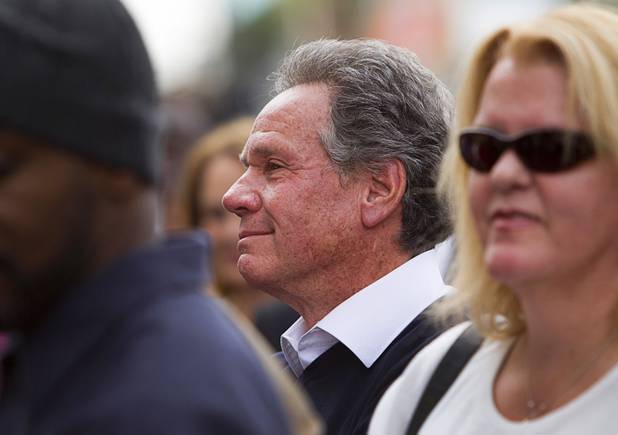 Wynn Resorts board member and executive Marc Schorr watches as his son Seth Schorr, CEO of the Downtown Grand, presides over an official opening ceremony for the Downtown Grand in downtown Las Vegas Tuesday, Nov. 12, 2013.
