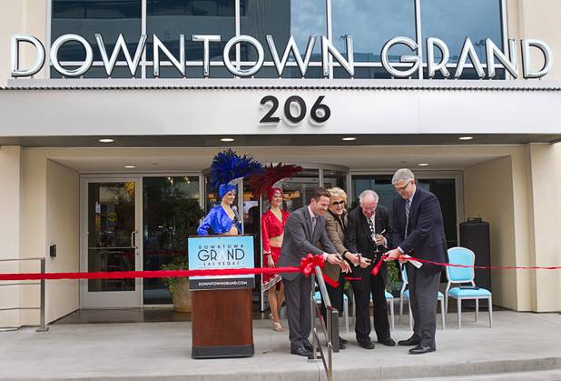 From left, Seth Schorr, CEO of the Downtown Grand, Las Vegas Mayor Carolyn Goodman, former Mayor Oscar Goodman and Bill Doak, first vice president at CIM Group, cut a ribbon during an official opening ceremony for the Downtown Grand in downtown Las Vegas Tuesday, Nov. 12, 2013.