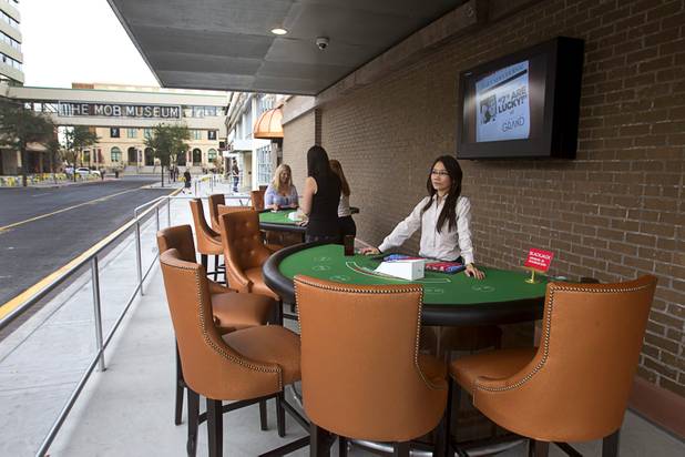 Dealer Teerana Praznovsky waits for players on Third Street following an official opening ceremony for the Downtown Grand in downtown Las Vegas Tuesday, Nov. 12, 2013.