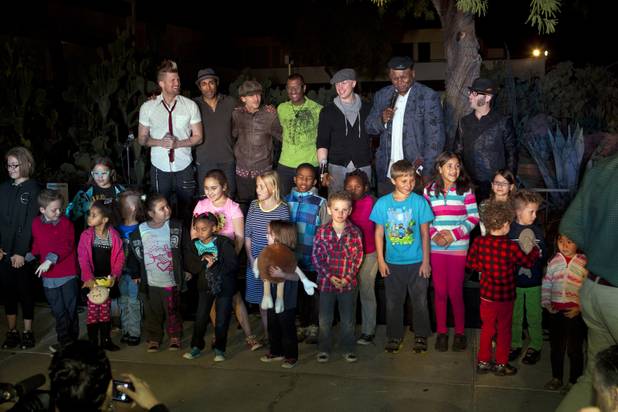 George Wallace, Michael Grimm and MO5AIC members pose for pictures on stage with a group of kids attending the 20th anniversary of Ethel M's Cactus Lighting on Tuesday, Nov. 12, 2013.