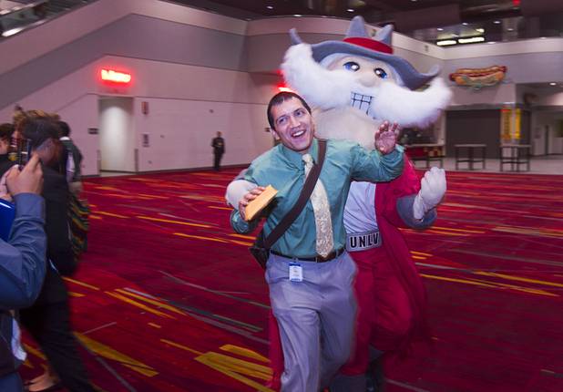 UNLV's mascot Hey Reb chases after Vince Medina, a a government teacher at Western High School, during the annual Las Vegas Sun Youth Forum at the Las Vegas Convention Center Wednesday, Nov. 13, 2013.