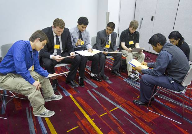 Students confer in a small group before debating issues during the annual Las Vegas Sun Youth Forum at the Las Vegas Convention Center Wednesday, Nov. 13, 2013.