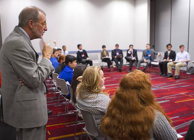 Moderator Robert McCord, left, an emeritus associate professor in educational leadership at UNLV, listens to a student discussion on international issues during the annual Las Vegas Sun Youth Forum at the Las Vegas Convention Center Wednesday, Nov. 13, 2013.
