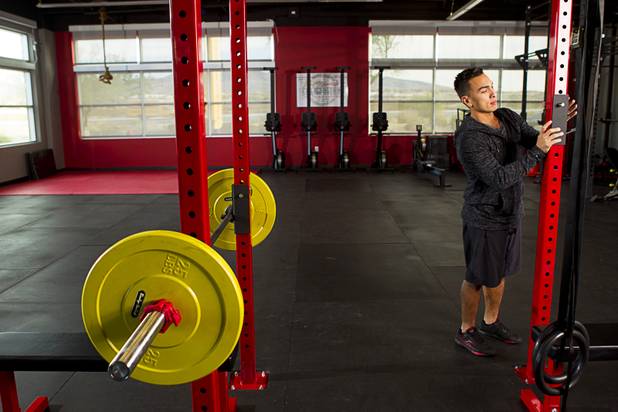 Boris Sapone, owner and founder of the Colosseum Training Center, adjusts a rack for squats at the center, in the Cashman Equipment complex on St. Rose Parkway, Thursday, Nov. 14, 2013.