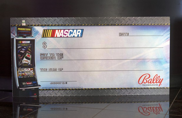 A oversized check for the Bally Technologies' NASCAR slot machines is shown at the company Thursday, Nov. 14, 2013. A Jackpot Response Team member is always on call in the event that a gambler hits a progressive jackpot on a Bally Technologies slot machine.