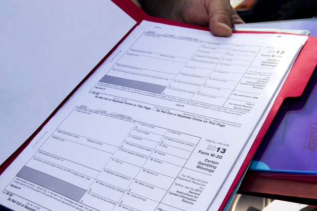 E.J. Coyle, a project manager at Bally Technologies, displays W-2G Internal Revenue Service forms at the company Thursday, Nov. 14, 2013. Coyle is a member of the Jackpot Response Team. A member is always on call in the event that a gambler hits a progressive jackpot on a Bally Technologies slot machine.