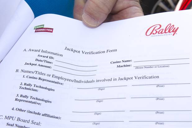 E.J. Coyle, a project manager at Bally Technologies, displays a jackpot verification form at the company Thursday, Nov. 14, 2013. Coyle is a member of the Jackpot Response Team. A member is always on call in the event that a gambler hits a progressive jackpot on a Bally Technologies slot machine.