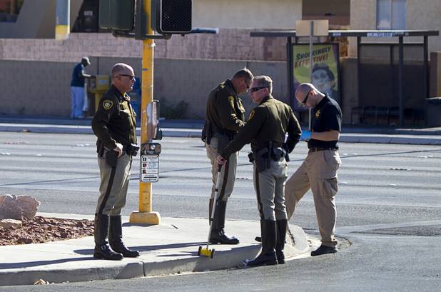 Metro Police officers confer at the scene of a fatal motorcycle accident at the intersection of Flamingo and Lindell roads Thursday, Nov. 14, 2013.