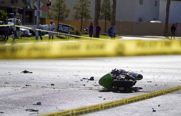 A motorcycle is shown at a fatal accident scene at the intersection of Flamingo and Lindell roads Thursday, Nov. 14, 2013.