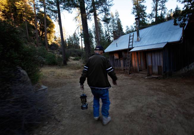 Jack English, 94, walks with a lanter outside his remote cabin in the Ventana Wilderness of California on Nov. 17, 2013.