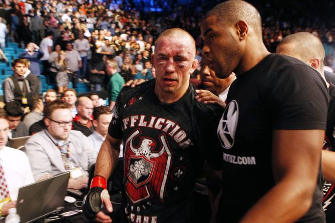 A battered Georges St. Pierre leaves the MGM Grand Garden Arena after his fight with Johny Hendricks at UFC 167 Saturday, Nov. 16, 2013 at the MGM Grand Garden Arena. St. Pierre won with a controversial split decision.