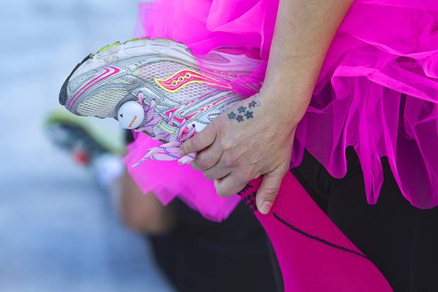 Half-marathon runner Dawn Petrovich of Ridgecrest, Calif. stretches before the 5th annual Rock 'n' Roll Las Vegas Marathon Sunday, Nov. 17, 2013.