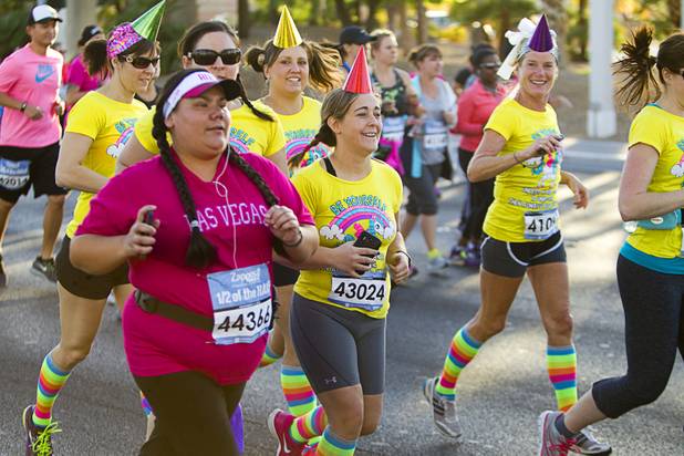 Runners head out at the start of the Zappos.com "1/2 of the Half" run during the 5th annual Rock 'n' Roll Las Vegas Marathon Sunday, Nov. 17, 2013.