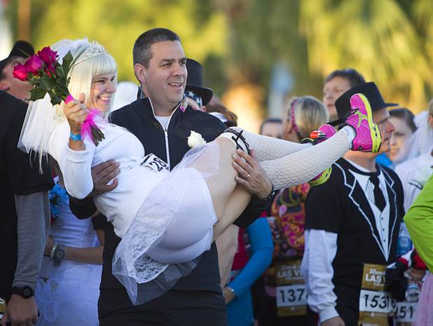 Angela and Alex Marshall of Raleigh, N.C. pose for a photo before renewing their vows at the 5th annual Rock 'n' Roll Las Vegas Marathon Sunday, Nov. 17, 2013.