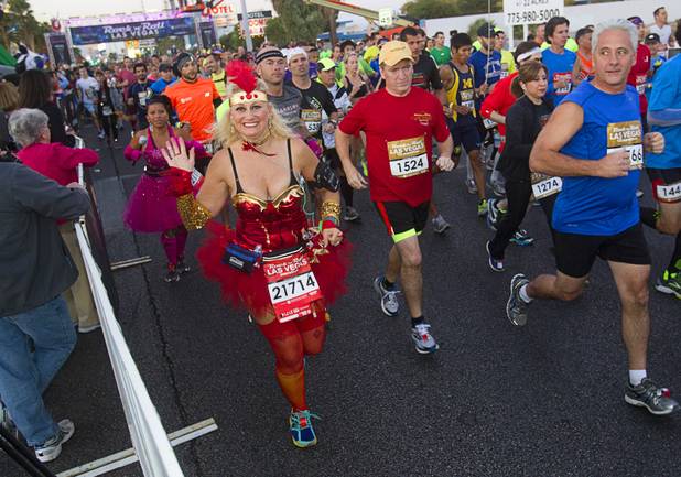 Half-marathon runners head out from the start line during the 5th annual Rock 'n' Roll Las Vegas Marathon Sunday, Nov. 17, 2013.