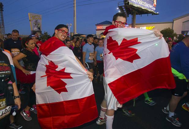 Canandian runners display their flags as the wait to start the half-marathon run during the 5th annual Rock 'n' Roll Las Vegas Marathon Sunday, Nov. 17, 2013.