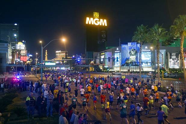 Half-marathon runners cross Tropicana Boulevard during the 5th annual Rock 'n' Roll Las Vegas Marathon Sunday, Nov. 17, 2013.