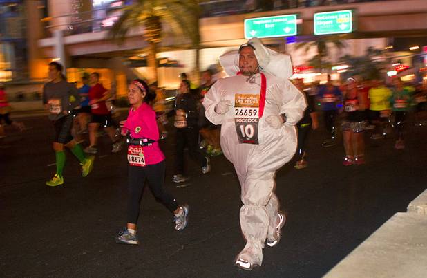A costumed runner participates in the 5th annual Rock 'n' Roll Las Vegas Half Marathon Sunday, Nov. 17, 2013.