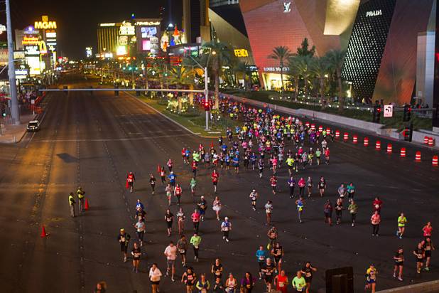 Runners change lanes near Harmon Avenue during the 5th annual Rock 'n' Roll Las Vegas Marathon Sunday, Nov. 17, 2013.