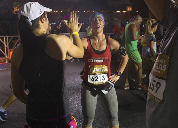 Runners give each other a high five after completing the 5th annual Rock 'n' Roll Las Vegas Half Marathon Sunday, Nov. 17, 2013.