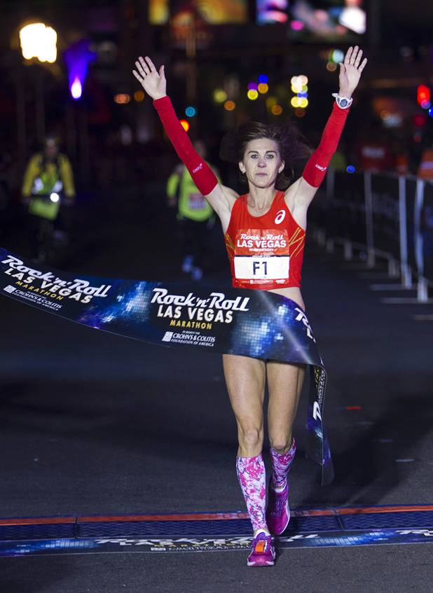 First place female runner Nuta Olaru of Romania crosses the finish line during the 5th annual Rock 'n' Roll Las Vegas Marathon Sunday, Nov. 17, 2013. Olaru finished with a time of 2 hours, 58 minutes, and 46 seconds.