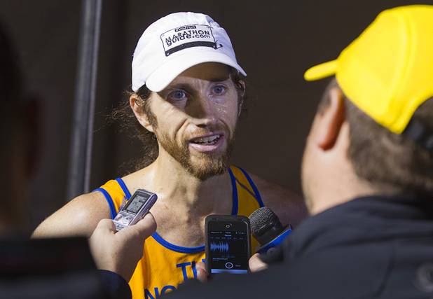 Tenth place finisher Michael Wardian of Arlington, Va. talks with reporters after finishing the 5th annual Rock 'n' Roll Las Vegas Marathon Sunday, Nov. 17, 2013. Wardian won the Rock n Roll San Antonio Marathon then flew to Las Vegas and completed the Las Vegas Marathon on the same day. Wardian's winning time in San Antonio was 2 hours, 31 minutes and 19 seconds.