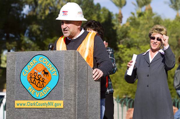 Chris Brooks of Bombard Renewable Energy speaks during a groundbreaking ceremony at the "Welcome to Fabulous Las Vegas" sign on Las Vegas Boulevard South Monday, Nov. 18, 2013. Clark County Commissioner Chris Giunchigliani cheers at right. The groundbreaking was for a photovoltaic solar installation which will power the sign. The project is funded by donations from the Consumer Electronics Association, NV Energy, the Las Vegas Centennial Commission and Bombard Renewable Energy.
