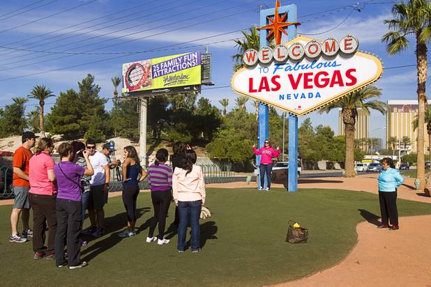 Tourists take photos following a groundbreaking ceremony at the "Welcome to Fabulous Las Vegas" sign on Las Vegas Boulevard South Monday, Nov. 18, 2013. The groundbreaking was for a photovoltaic solar installation which will power the sign. The project is funded by donations from the Consumer Electronics Association, NV Energy, the Las VegasCentennial Commission and Bombard Renewable Energy.
