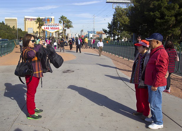 Korean tourists take photos following a groundbreaking ceremony at the "Welcome to Fabulous Las Vegas" sign on Las Vegas Boulevard South Monday, Nov. 18, 2013. The groundbreaking was for a photovoltaic solar installation which will power the sign. The project is funded by donations from the Consumer Electronics Association, NV Energy, the Las VegasCentennial Commission and Bombard Renewable Energy.