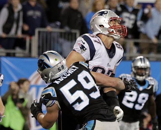 Carolina Panthers' Luke Kuechly (59) blocks New England Patriots' Rob Gronkowski (87) on the final play during the second half of an NFL football game in Charlotte, N.C., Monday, Nov. 18, 2013. The Panthers won 24-20. 