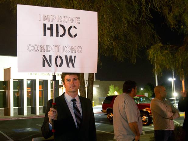 UNLV law student Drew Wheaton pickets outside the Henderson Detention Center Tuesday, Nov. 19, 2013. Protesters are concerned about a UNLV law clinic report that raises questions about the conditions for immigrants at the detention center.