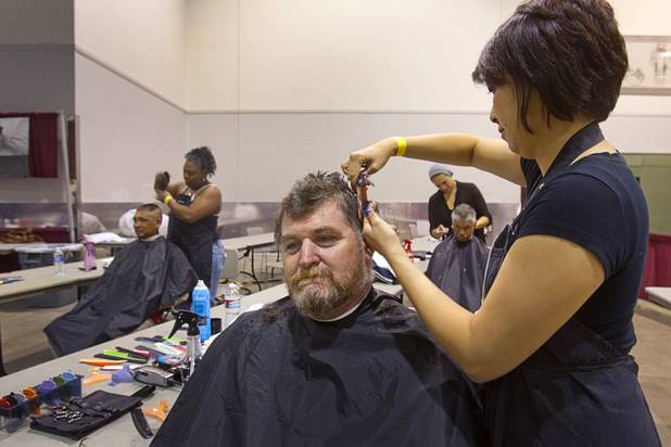 Robbie Ashley gets a haircut from stylist Rachel Dombrigues, owner of Urban Hair Company, during the Fall 2013 Southern Nevada Project Homeless Connect at Cashman Field Center Tuesday, Nov. 19, 2013. The annual event brings together a variety of social and legal services to help homeless and low-income people. STEVE MARCUS