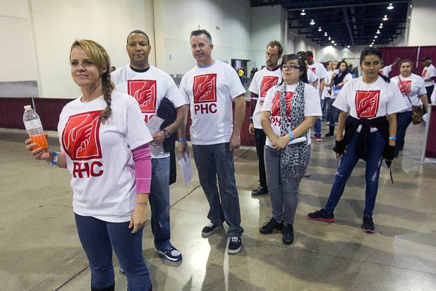 Tina Thompson, left, and other volunteers wait to escort guests during the Fall 2013 Southern Nevada Project Homeless Connect at Cashman Field Center Tuesday, Nov. 19, 2013. The annual event brings together a variety of social and legal services to help homeless and low-income people.