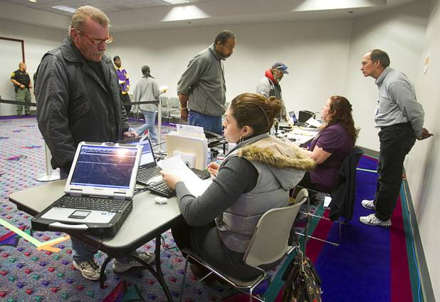 Randy Evans, left, talks with Municipal Court specialist Rocia Portillo during the Fall 2013 Southern Nevada Project Homeless Connect at Cashman Field Center Tuesday, Nov. 19, 2013. Evans was taking care of a ticket he received for jaywalking, he said. The annual event brings together a variety of social and legal services to help homeless and low-income people.