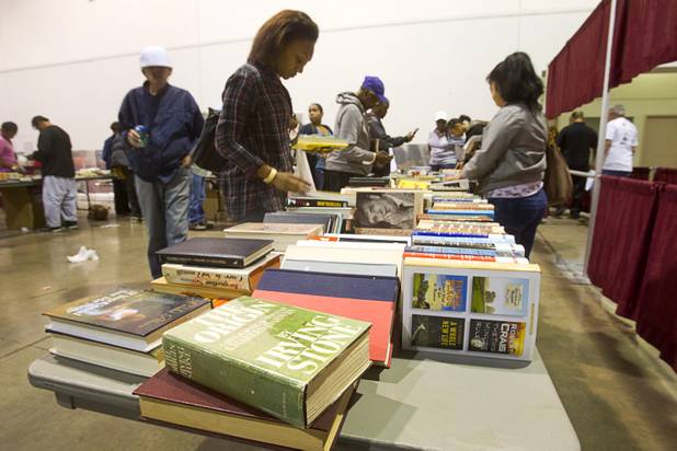 People look through a table of free books during the Fall 2013 Southern Nevada Project Homeless Connect at Cashman Field Center Tuesday, Nov. 19, 2013. The annual event brings together a variety of social and legal services to help homeless and low-income people.