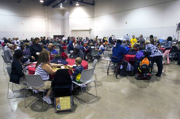 People eat lunch prepared by Culinary Academy of Las Vegas students during the Fall 2013 Southern Nevada Project Homeless Connect at Cashman Field Center Tuesday, Nov. 19, 2013. The annual event brings together a variety of social and legal services to help homeless and low-income people.
