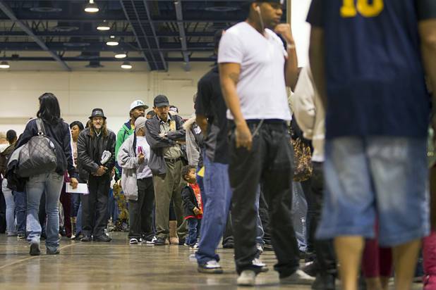 People wait in a line to Las Vegas Municipal and Justice courts during the Fall 2013 Southern Nevada Project Homeless Connect at Cashman Field Center Tuesday, Nov. 19, 2013. Many people took advantage of the court services to take care of minor violations or warrants. The annual event brings together a variety of social and legal services to help homeless and low-income people.