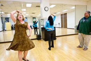 Maureen Vocke, from left, and Lydia Noyola act out a dance scene as Emerson Williams watches from the side while participating in a new acting class for adults at the Charleston Heights Arts Center in Las Vegas November 20, 2013.