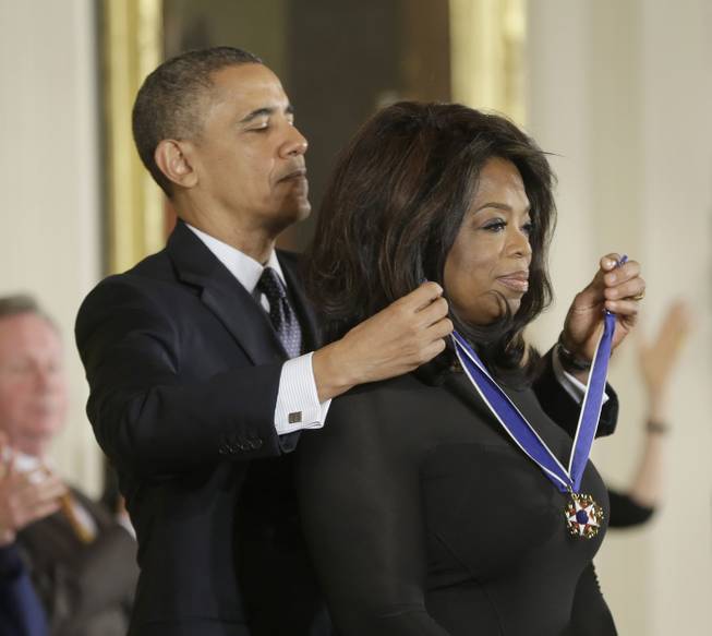 President Barack Obama awards Oprah Winfrey the Presidential Medal of Freedom, Wednesday, Nov. 20, 2013, in the East Room of the White House in Washington.