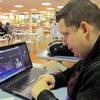 Joseph Brennen of Ventnor, N.J., logs on to a Harrah's online casino on his laptop from a highway rest area in Egg Harbor Township, N.J. on Thursday, Nov. 21, 2013, the first day of a test of Internet gambling in New Jersey.