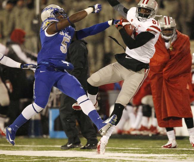 UNLV wide receiver Devante Davis, right, goes out of bounds after pulling in a pass in front of Air Force strong safety Dexter Walker in the first quarter of an NCAA football game at Air Force Academy, Colo., on Thursday, Nov. 21, 2013. (AP Photo/David Zalubowski)