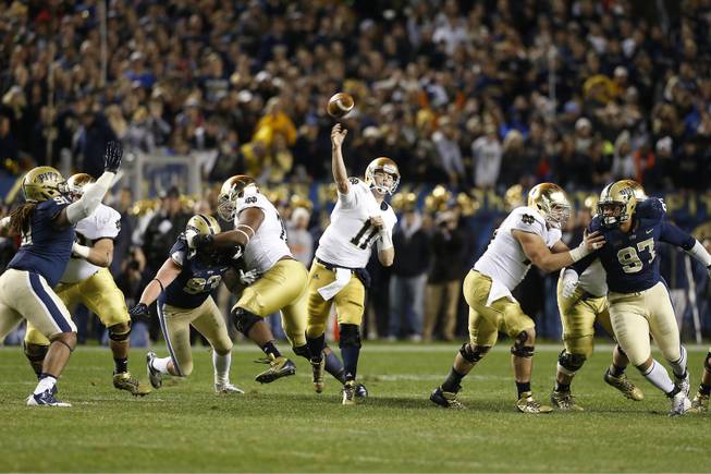 Notre Dame quarterback Tommy Rees (11)passes as Pittsburgh defensive lineman Aaron Donald (97) and Pittsburgh defensive lineman Darryl Render (91) pursue in the fourth quarter of an NCAA college football game on Saturday, Nov. 9, 2013, in Pittsburgh. Pittsburgh won 28-21.