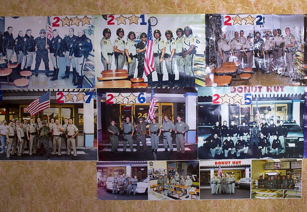 Photos of Sothy Seang, 57, posing with Metro Police officers cover a wall at the Donut Hut, 3242 E Desert Inn Rd., Sunday, Nov. 24, 2013. Seang fought with the Cambodian army against the Viet Cong during the Vietnam War. He later immigrated to the U.S. He has owned the Donut Hut in Las Vegas for 22 years.