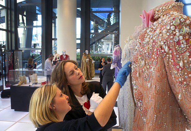 Shannon Nutt, left assistant curator, and curator Dierdra Clemente look over a Liberace costume prior to the opening of "Too Much of a Good Thing Is Wonderful: Liberace and the Art of Costume" in the Cosmopolitan Monday, Nov. 25, 2013. The exhibit opened Monday and will run through Jan.1, 2014. Admission is free but any donations will benefit the Liberace Foundations scholarship fund.