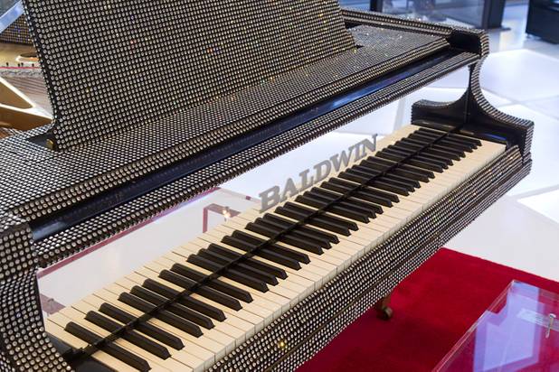 A rhinestone-covered grand piano is displayed at "Too Much of a Good Thing Is Wonderful: Liberace and the Art of Costume" in the Cosmopolitan Monday, Nov. 25, 2013. The exhibit opened Monday and will run through Jan.1, 2014. Admission is free but any donations will benefit the Liberace Foundations scholarship fund.