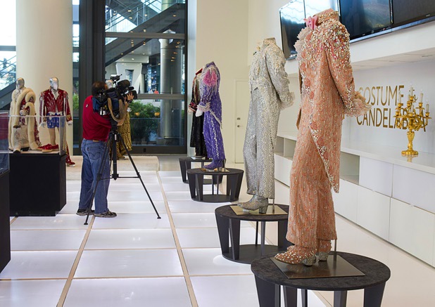 A news photographer takes video of costumes prior to the opening of "Too Much of a Good Thing Is Wonderful: Liberace and the Art of Costume" in the Cosmopolitan Monday, Nov. 25, 2013. The exhibit opened Monday and will run through Jan.1, 2014. Admission is free but any donations will benefit the Liberace Foundations scholarship fund.