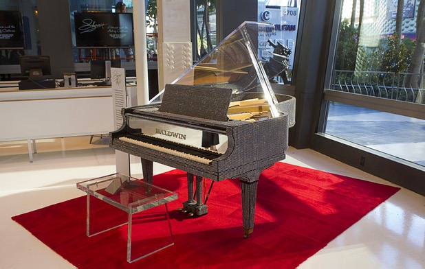 A rhinestone-covered grand piano is displayed at "Too Much of a Good Thing Is Wonderful: Liberace and the Art of Costume" in the Cosmopolitan Monday, Nov. 25, 2013. The exhibit opened Monday and will run through Jan.1, 2014. Admission is free but any donations will benefit the Liberace Foundations scholarship fund.