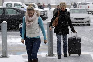 Holiday travelers walk to arrive at Pittsburgh International Airport in Imperial, Pa., Tuesday, Nov. 26, 2013. Winter weather advisories and storm warnings have been posted for much of Pennsylvania as a storm bearing a wintry mix of precipitation rolls into the commonwealth. 
