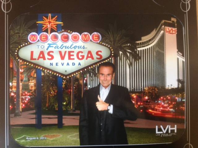 David Atwell shown in front of a Welcome To Fabulous Las Vegas sign display at LVH in August.